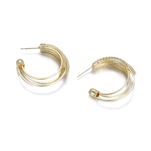 Detailed view of gold-plated triple-layer C-shape stud earrings with micro-set zircons
