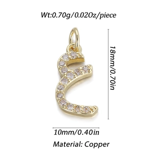Macro detail of gold Arabic letter pendant with white zircon stones and hanging loop