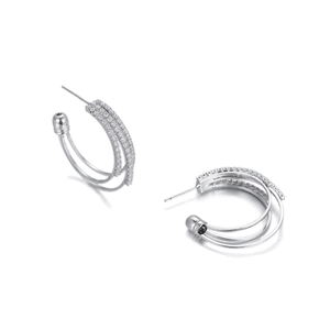 Macro detail of silver S925 earrings with triple-hoop design and micro-pave cubic zirconia