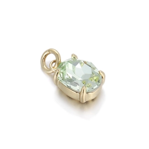 Detail view of cushion-cut light green gemstone pendant with gold-plated four-prong setting