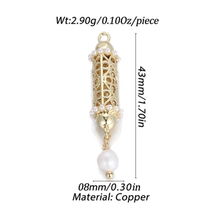 Detailed view of cylindrical gold-plated copper pendant with hollow patterns and pearls