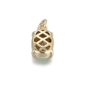 Macro view of geometric gold-plated pendant with hollow diamond pattern and green stone