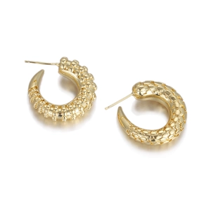 Detail of golden C-shaped hoop earrings with textured bead and scale patterns
