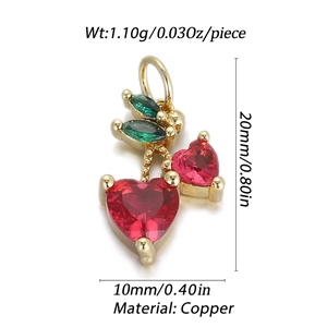 Detailed macro view of 14K gold plated copper cherry pendant with red heart crystals