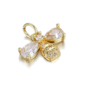 Macro shot of a 14K gold plated bee pendant with zircon wings and pave diamond abdomen