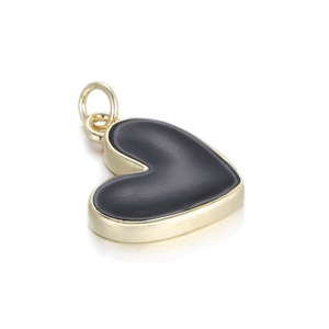 Macro shot of 14K gold plated heart charm with black enamel inlay and ring attachment