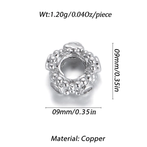 Detail of a 9mm gold-plated brass beaded spacer charm with polished silver finish for DIY jewelry