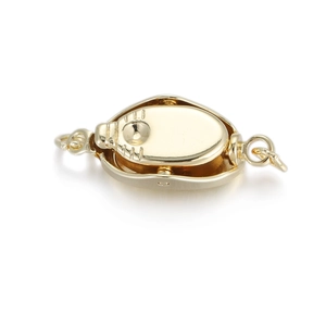 Macro view of 14K gold plated jewelry connector clasp with polished oval structure