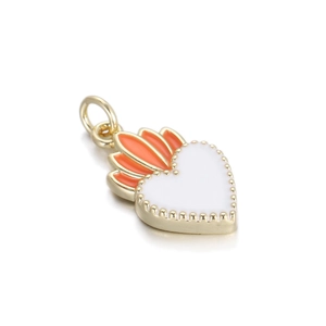 Detailed close-up of golden heart pendant with white enamel and orange flame detail