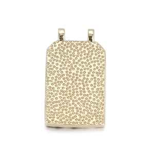 Detailed view of rectangular golden pendant with textured hammered finish and dual loops