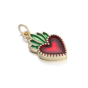 Close-up of heart-shaped enamel pendant with red finish and green leaf detail