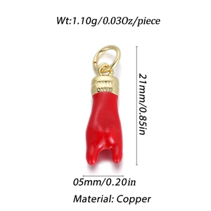 Macro detail of red enamel Italian horn pendant with 14K gold plated copper ring