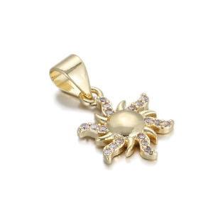 Detailed view of a 14K gold plated sun pendant with sparkling cubic zirconia accents