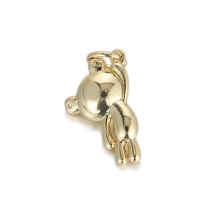 Close-up of a 3D gold bear pendant with a polished mirror finish and top metal ring