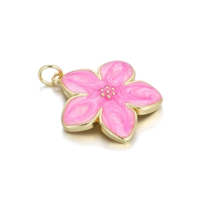 Detailed macro shot of a pink enamel cherry blossom pendant with gold-toned rim