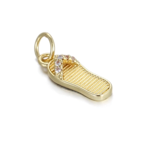 Close-up of a gold-plated flip-flop pendant with pink and white zircon stones
