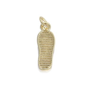 Close-up of a 14K gold plated flip-flop pendant with detailed horizontal stripes