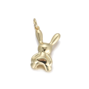 Detailed view of a shiny gold rabbit pendant with a smooth polished finish and top ring