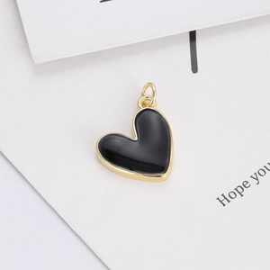Detail of matte black enamel heart pendant with 14K gold plated frame and bail