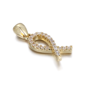 Macro detail of 14K gold plated ribbon pendant with sparkling cubic zirconia inlay