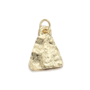 Close-up of golden hammered metal pendant showing detailed texture and craftmanship