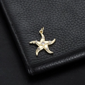 Detailed close-up of 14K gold plated starfish pendant with sparkling cubic zirconia stones