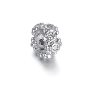 Detail of silver beaded pendant featuring heart-shaped cubic zirconia on a polished surface