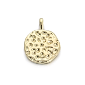 Detailed macro shot of 14K gold plated round pendant with irregular hammered texture