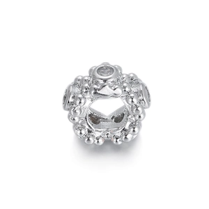 Macro shot of silver charm bead with clear cubic zirconia stones and spherical detailing
