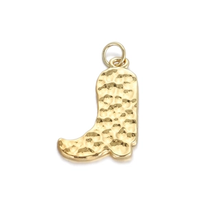Macro shot of gold-plated hammered texture cowboy boot metal pendant charm with top ring