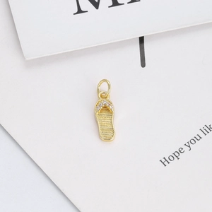 Detailed close-up of a 14K gold plated flip-flop pendant with sparkling white zircons
