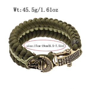 Detail view of olive green paracord survival bracelet with bronze skull and celtic clasp