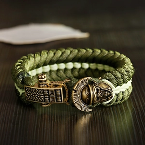 Macro shot of survival paracord bracelet with bronze Spartan helmet and skull buckle