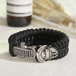 Close-up of black paracord bracelet with a vintage silver skull armor metal buckle