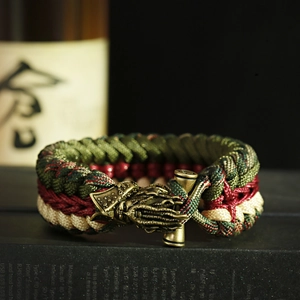 Macro detail of braided paracord bracelet featuring a bronze octopus-shaped metal buckle