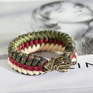 Detailed macro view of woven paracord bracelet with antique bronze dragon head clasp