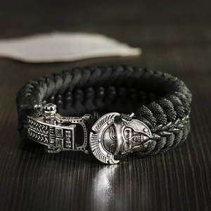 Close-up of parcord survival bracelet featuring a silver warrior skull and retro metal clasp