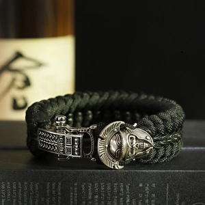 Close-up of paracord survival bracelet with silver Spartan helmet buckle and Greek key pattern
