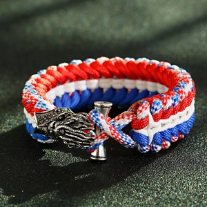 Detailed close-up of a tricolor paracord bracelet featuring a silver dragon head clasp