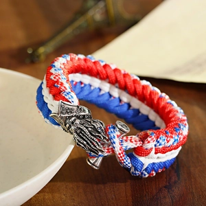 Close-up of tricolor paracord bracelet featuring a detailed vintage metal skull buckle