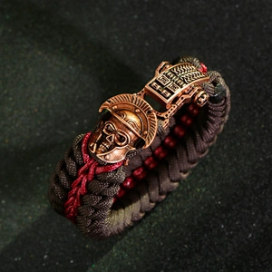 Close-up of parcord survival bracelet with bronze spartan skull helmet buckle
