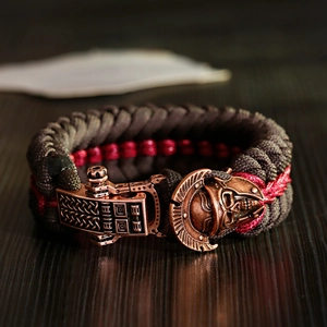 Macro detail of the braided paracord bracelet with antique bronze spartan helmet buckle