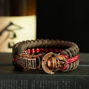 Macro shot of hand-woven paracord bracelet with antique bronze skull helmet buckle detail
