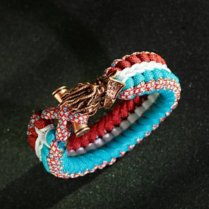 Detailed view of handmade paracord bracelet with antique bronze dragon head buckle