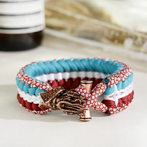 Detailed macro view of the handmade blue paracord weave with bronze octopus clasp