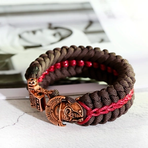 Macro detail of Spartan helmet skull clasp on braided paracord survival bracelet
