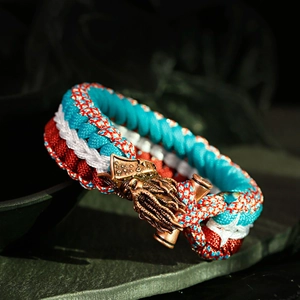 Detailed macro view of Paracord survival bracelet with dragon bronze metal buckle