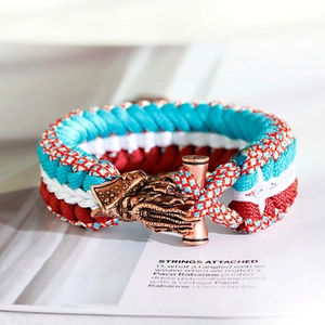 Macro shot of blue and red braided paracord bracelet with bronze octopus clasp and T-bar