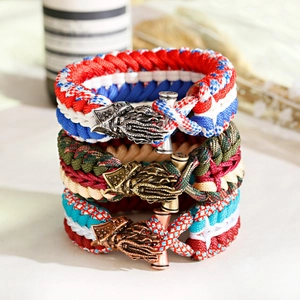Three-piece set of woven paracord bracelets with mythological creature metal toggles