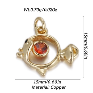 Detailed macro view of a golden fish pendant with orange gemstone and copper base